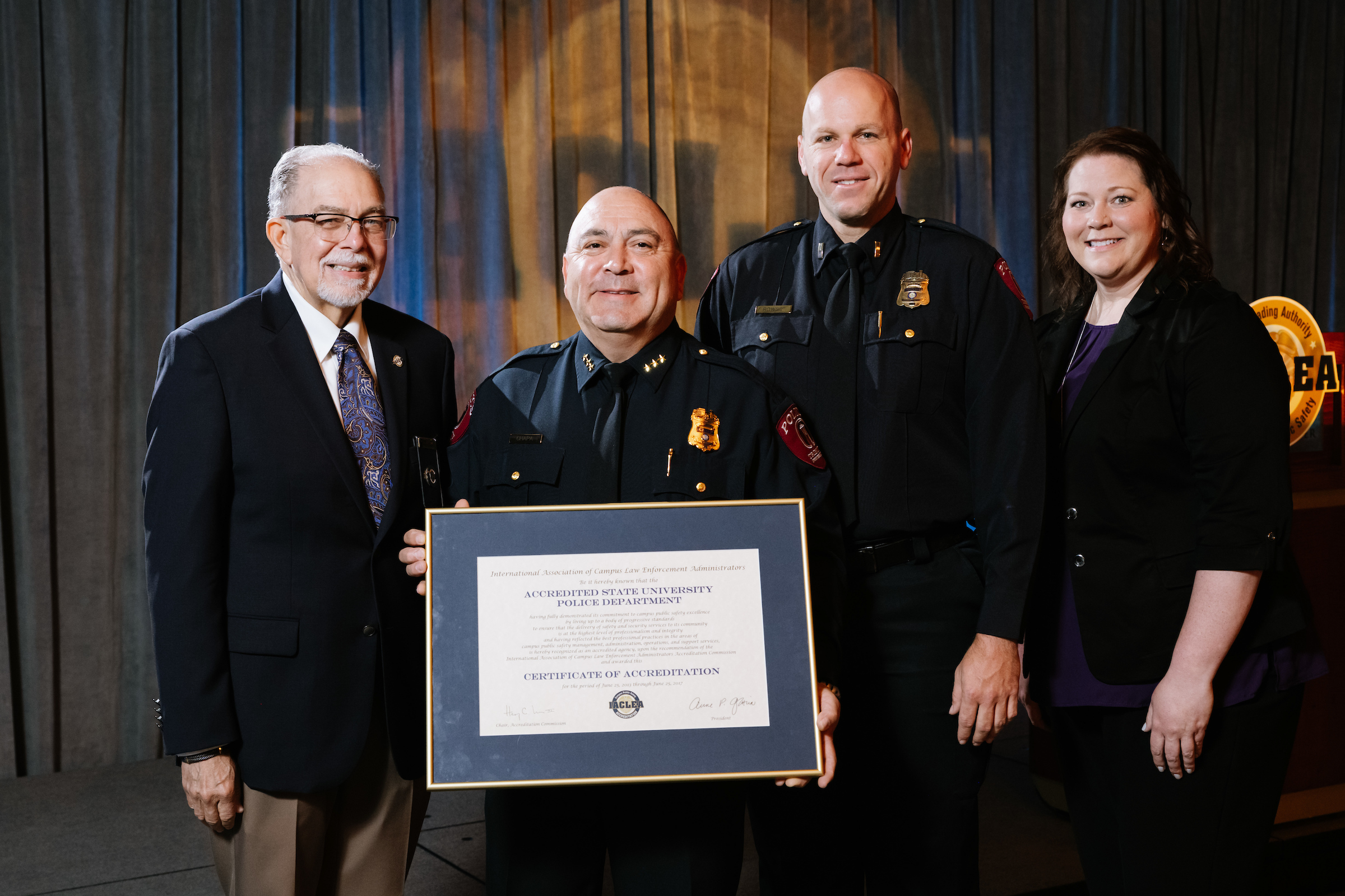 Chief Paul Chapa and Lt. John Rouse of Trinity University (Texas) Security and Safety Department receive recognition for achieving initial Accreditation during the 2019 Annual Conference & Exposition. © Mike Ritter